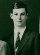 Young man in suit, posing for portrait.