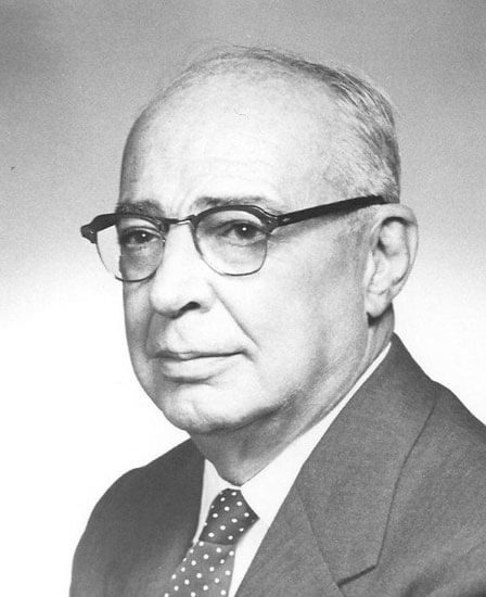 brooks-john-e Man with glasses, wearing suit and polka dot tie.