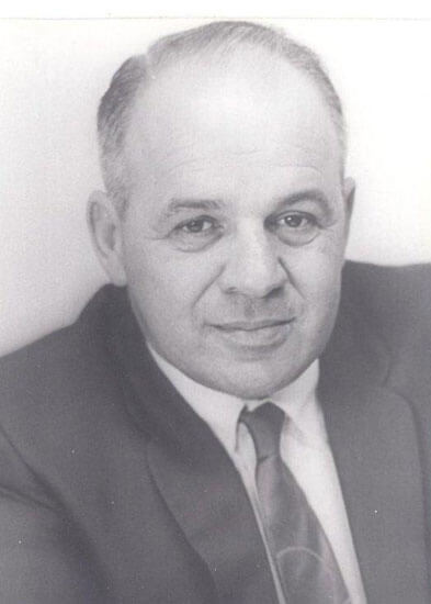 Man in suit poses for portrait photograph.
