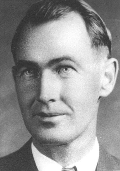Man in formal attire, looking slightly to the side.