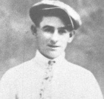 Young man in cap, wearing white shirt.
