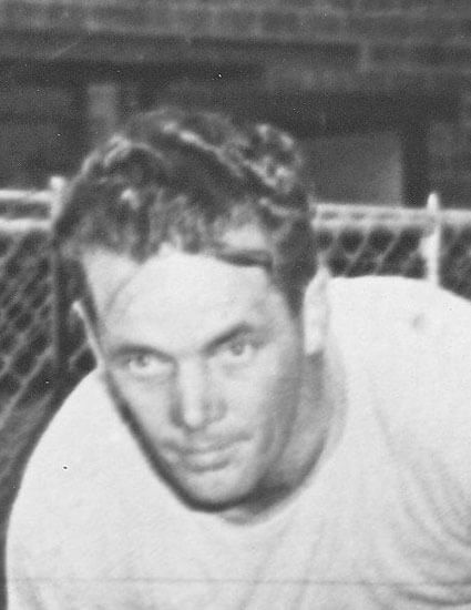 Man leaning forward, looking intently at something.