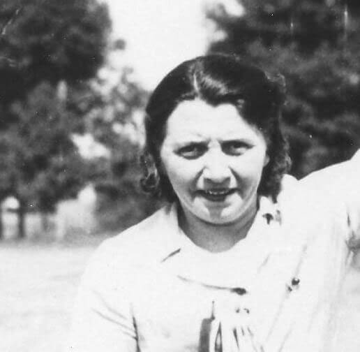haughn-mae-leesey A woman smiling outdoors, trees in background.