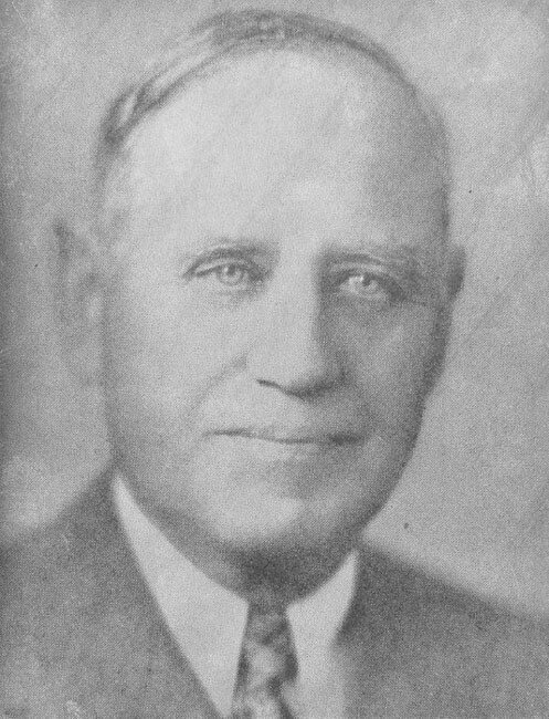 Man in formal attire, looking directly at camera.