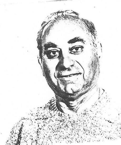 Smiling man looks directly at the camera.