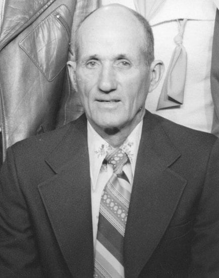 Man in suit posing for formal portrait.