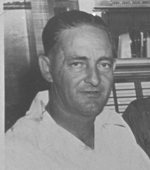 Man staring with a neutral expression indoors.