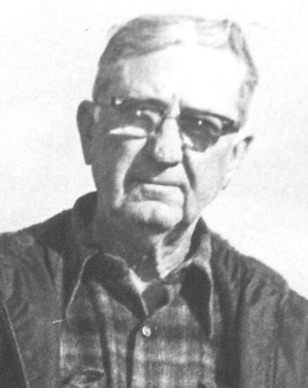 Elderly man wearing glasses, looking directly at camera.